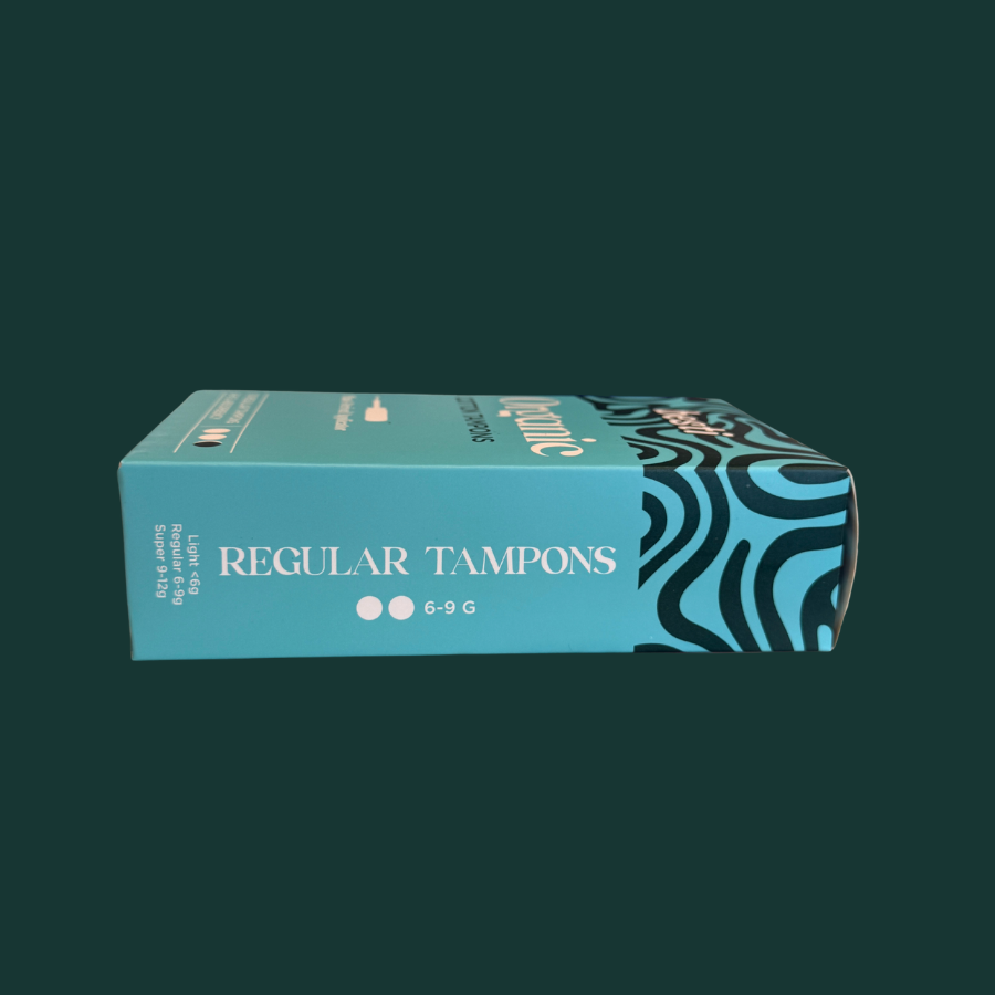 Box of regular tampons with a blue and black design on a dark green background