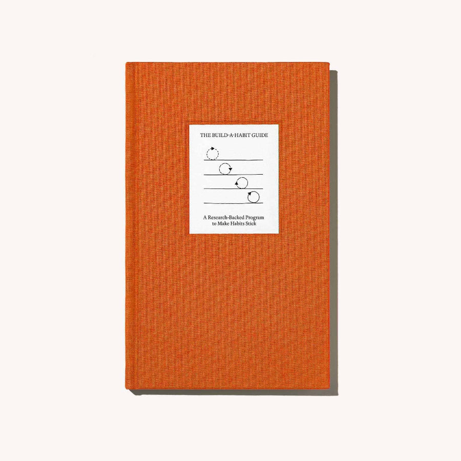 Orange book with a white label on a white background