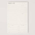 White daily list planner on a light gray background