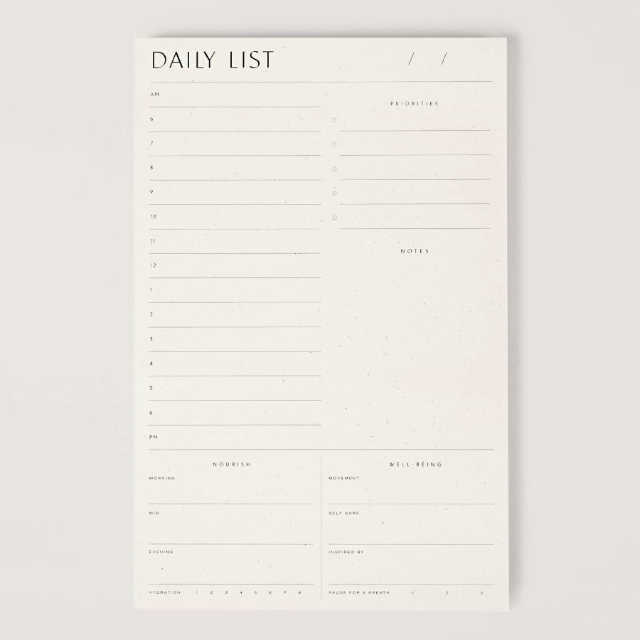 White daily list planner on a light gray background