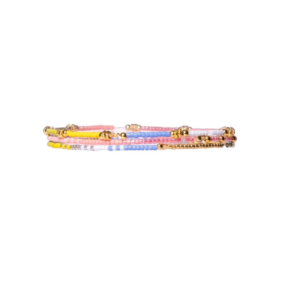 Set of colorful beaded bracelets on a white background