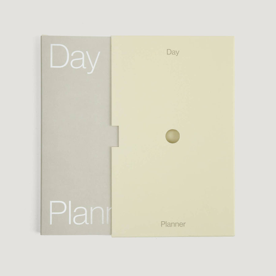 Two planners, one gray and one beige, on a white background