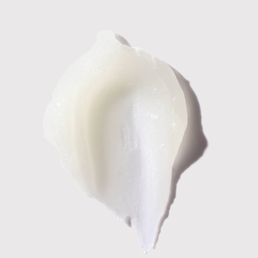 White cream or lotion swatch on a light gray background