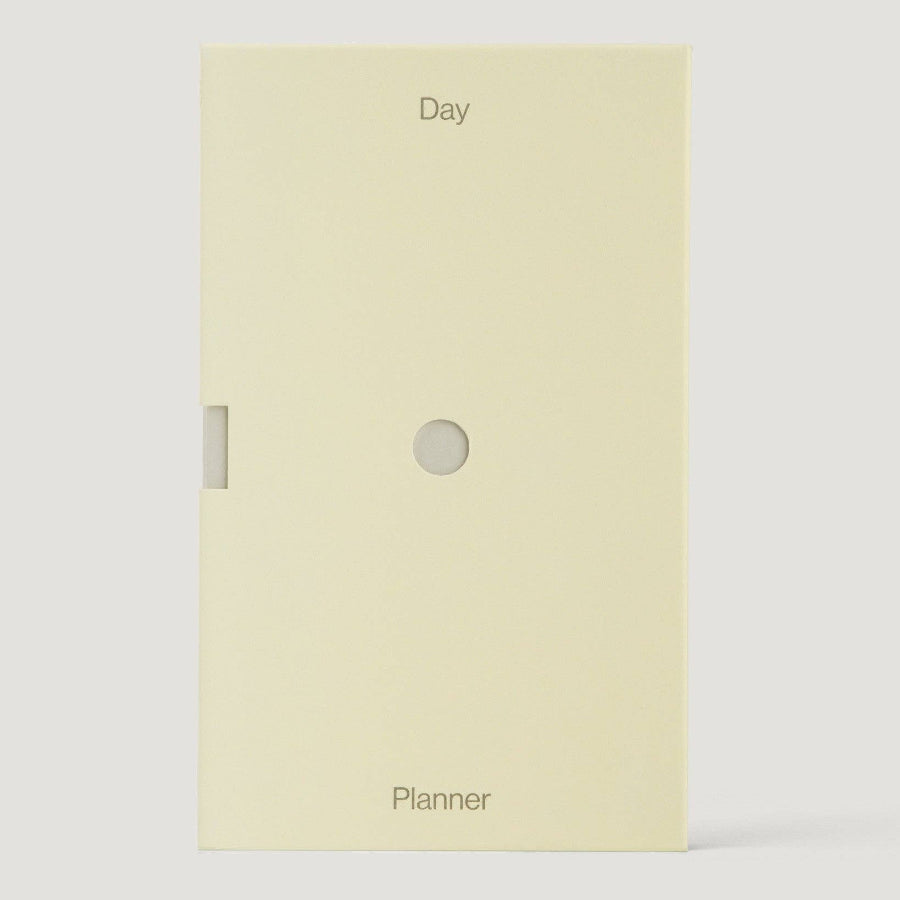 Beige planner with 'Day' and 'Planner' text on a white background
