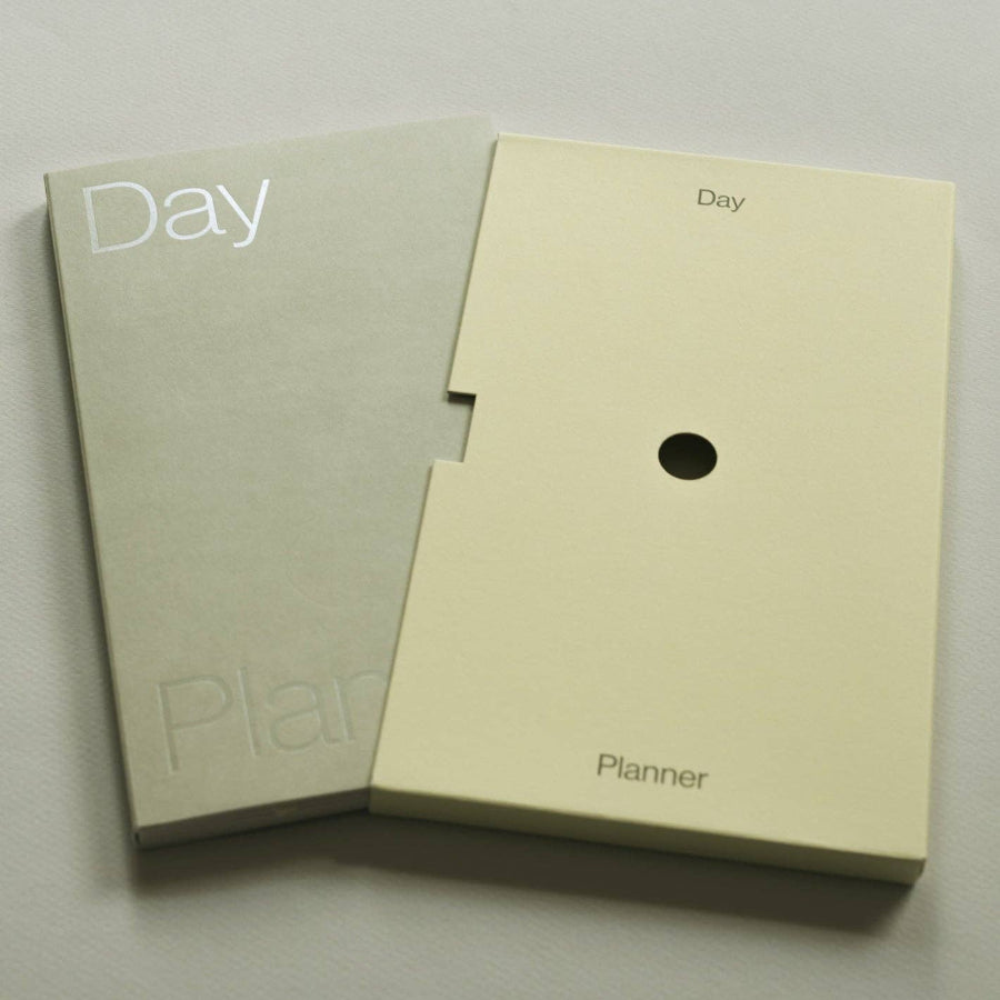 Two beige planners with 'Day Planner' text on a light gray background