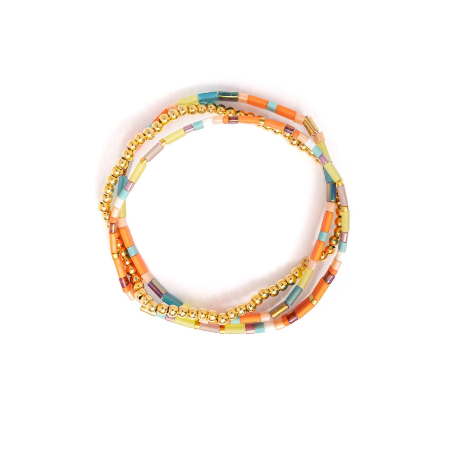 Set of colorful beaded bracelets on a white background