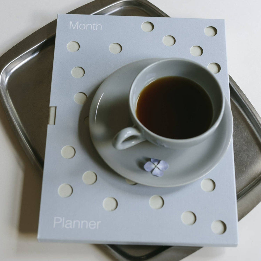 Planner with a coffee cup design on a metal tray