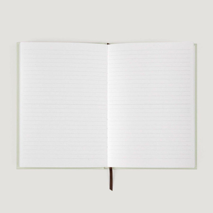 Open notebook with blank pages on a light gray background