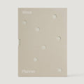 Beige planner with 'Week' and 'Planner' text on a white background