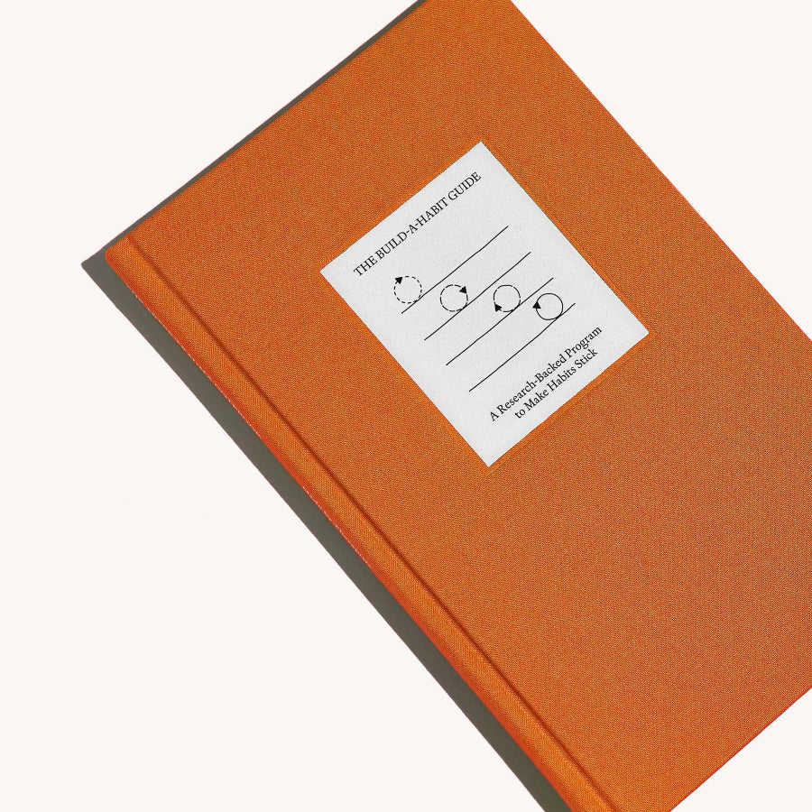 Orange book with a white label on a white background