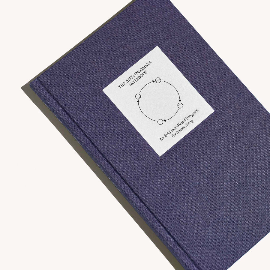 Navy blue notebook with a white label on a white background