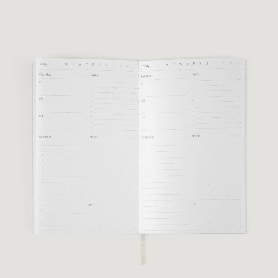 White planner with monthly layout on a white background