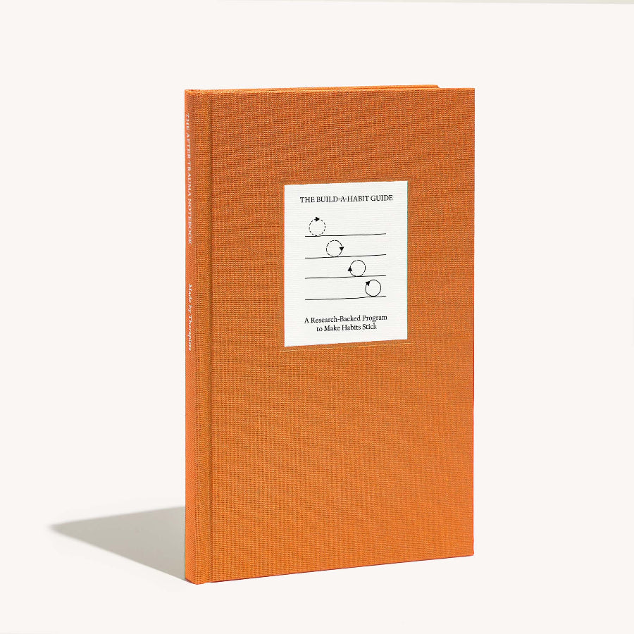 Orange book with a white label on a white background