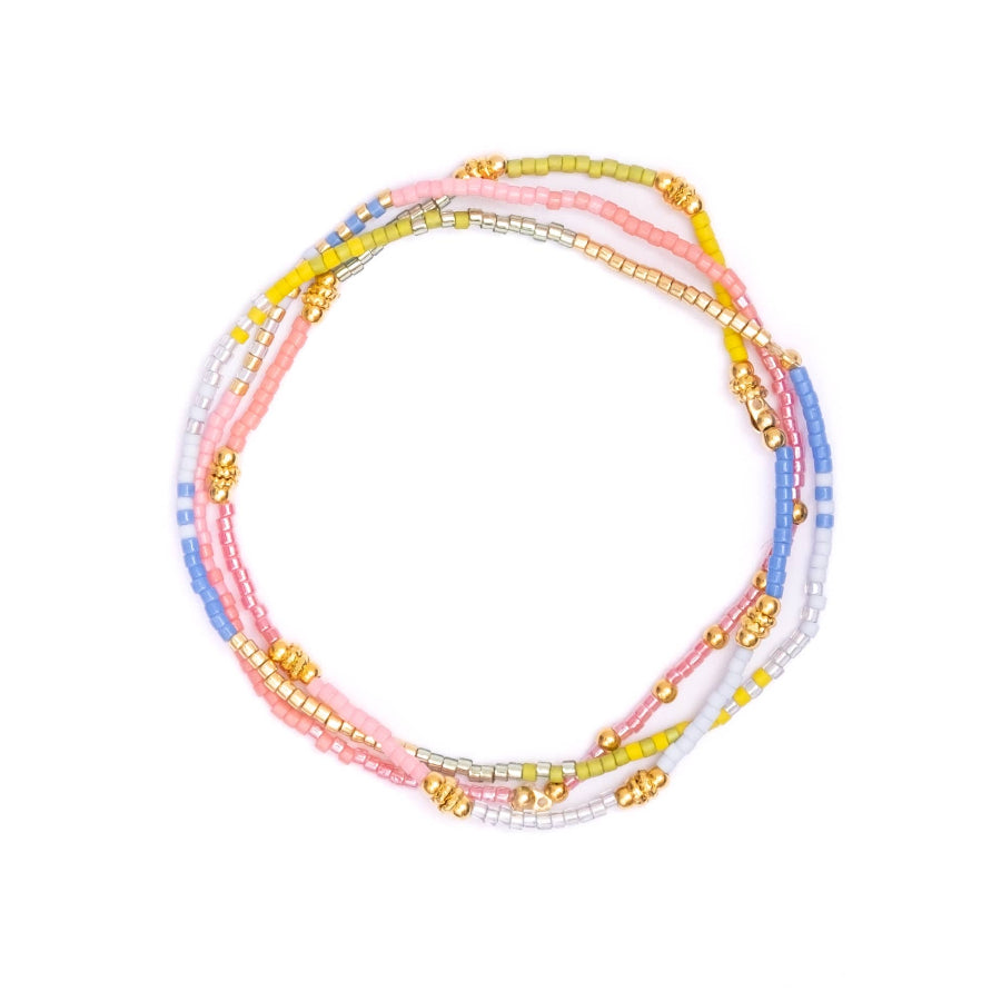 Set of colorful beaded bracelets on a white background