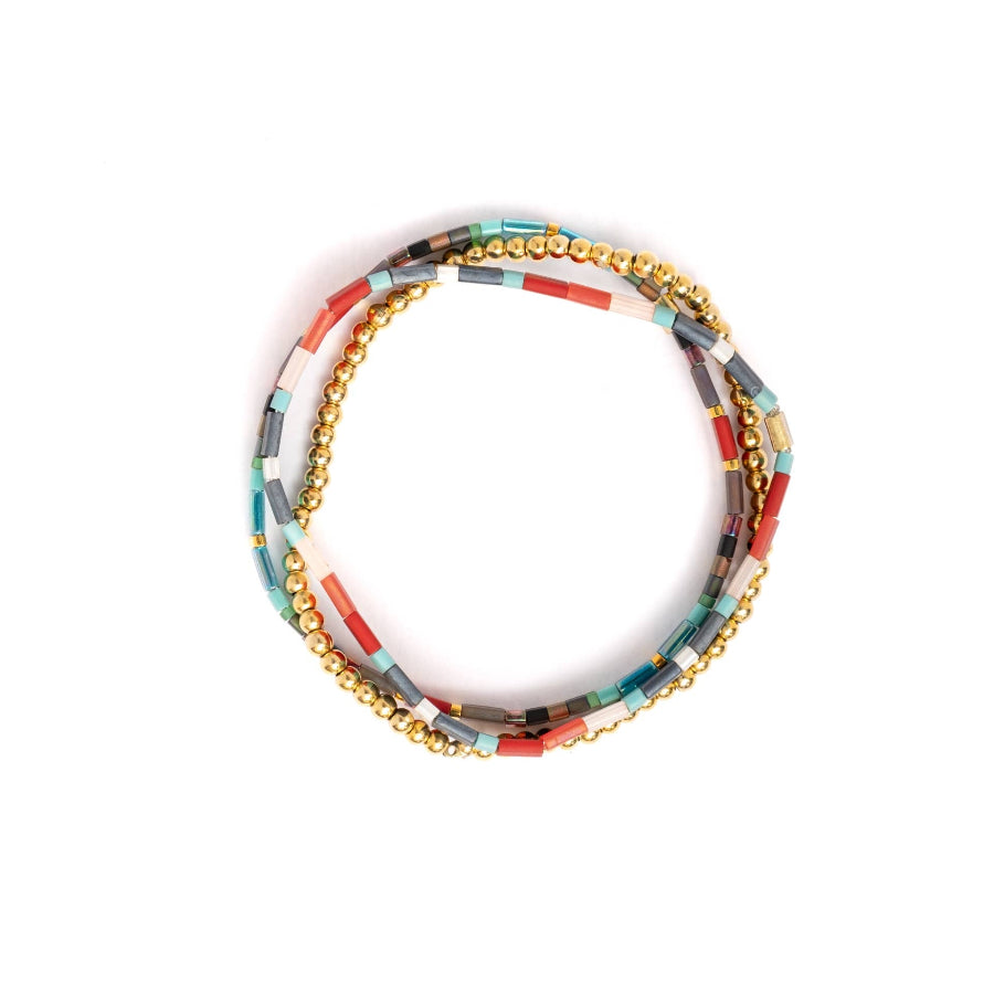Set of colorful beaded bracelets with gold accents on a white background