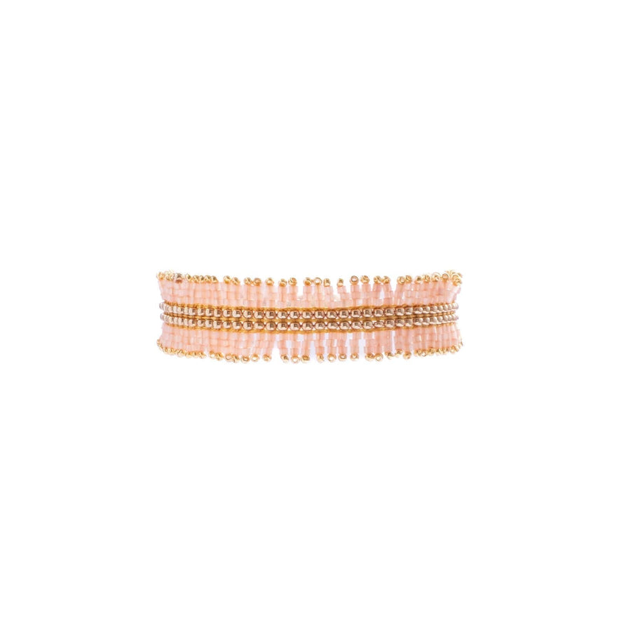Multiple bracelets stacked on a white background