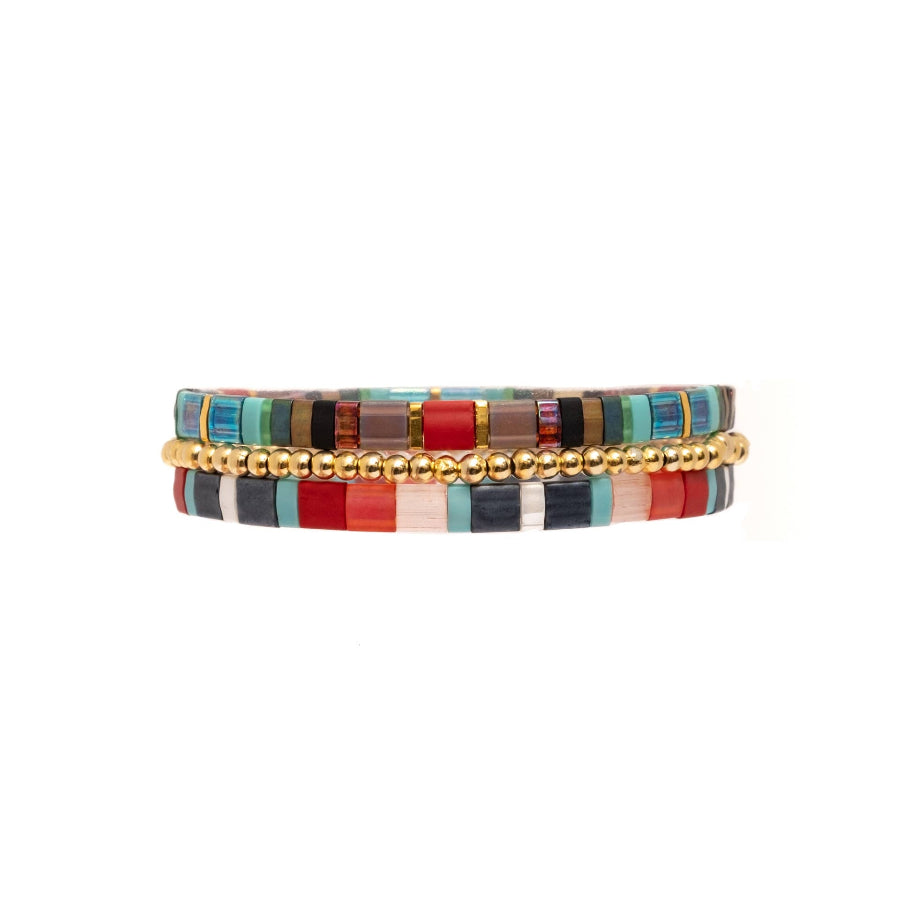 Multicolored beaded bracelet with gold accents on a white background