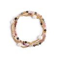 Set of multicolored beaded bracelets on a white background