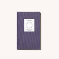 Purple notebook with a white label on a white background