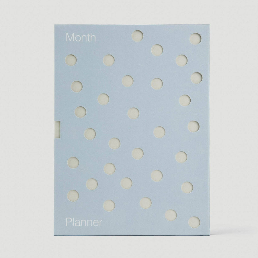 Planner with white polka dots on a light blue background