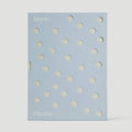 Planner with white polka dots on a light blue background