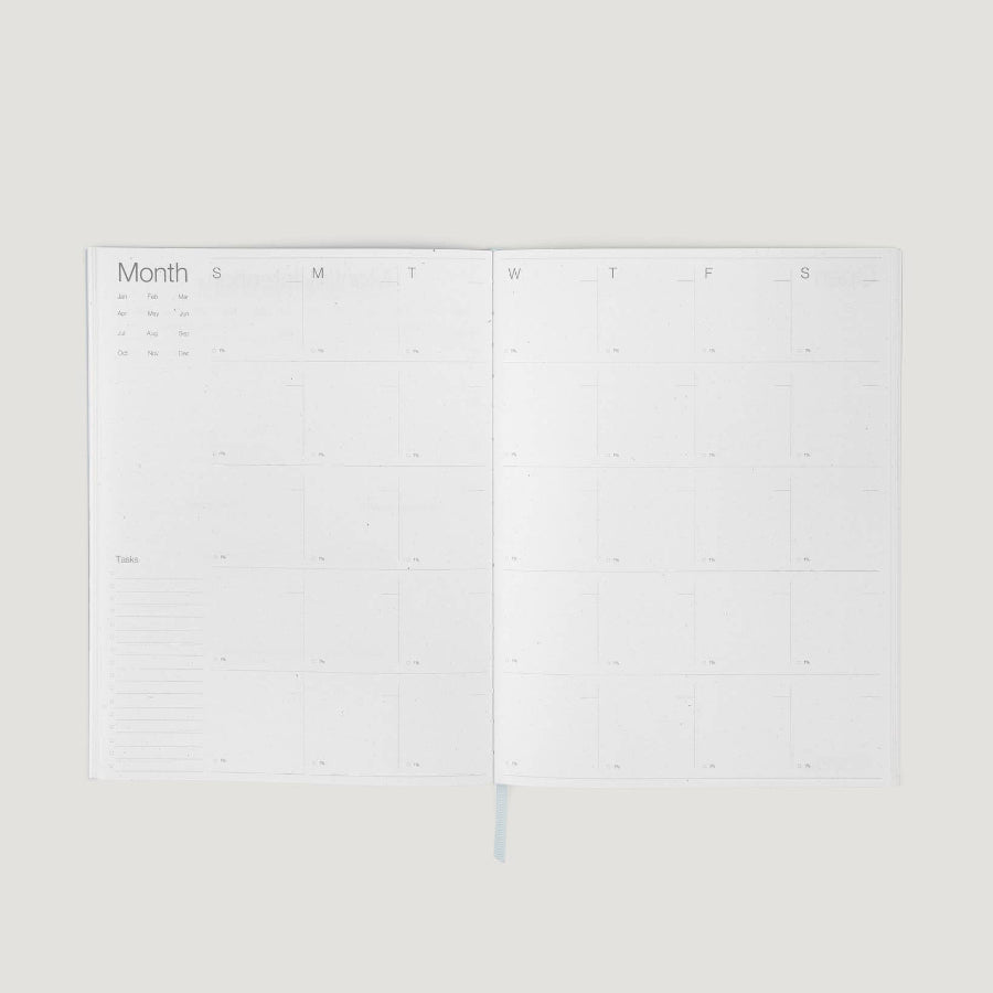 Two white calendar sheets on a light gray background