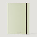 Light green notebook with a black strap on a white background